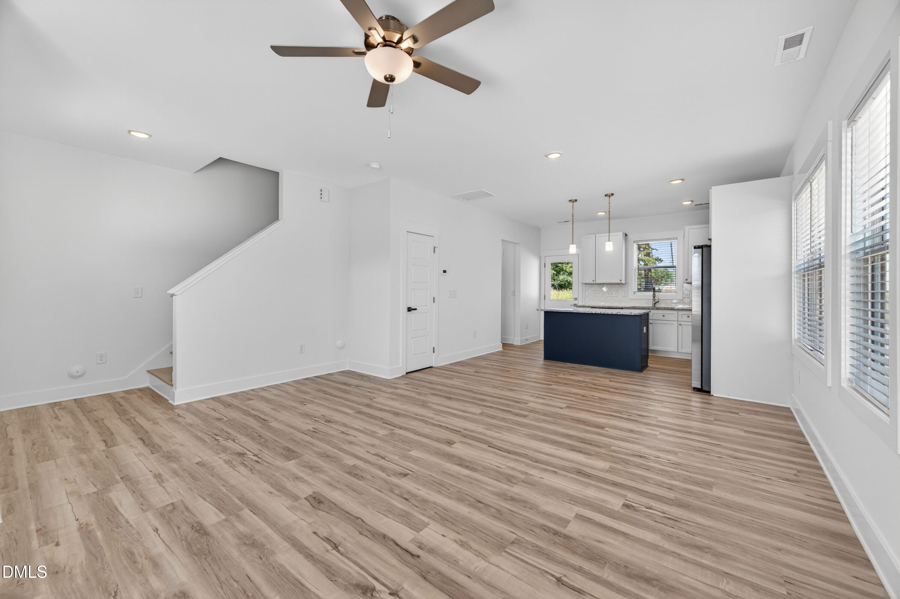 1256 Hurdle Mills Road Roxboro, NC 27573 - Photo 12 of 48 a view of empty room with wooden floor and windows