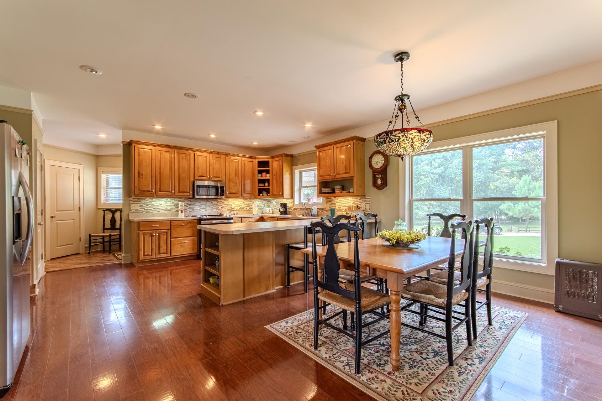 2690 Fellowship Road Sardis, TN 38371 - Photo 6 of 40 a view of a dining room and livingroom with furniture wooden floor a chandelier