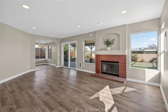 a view of an empty room with window and fire place