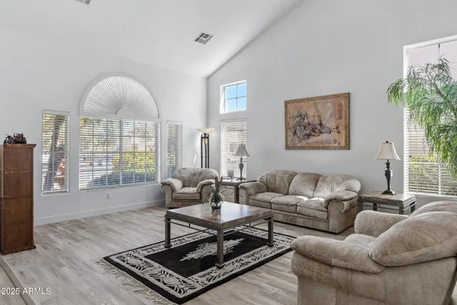 a kitchen with stainless steel appliances kitchen island granite countertop a sink a counter space and a window