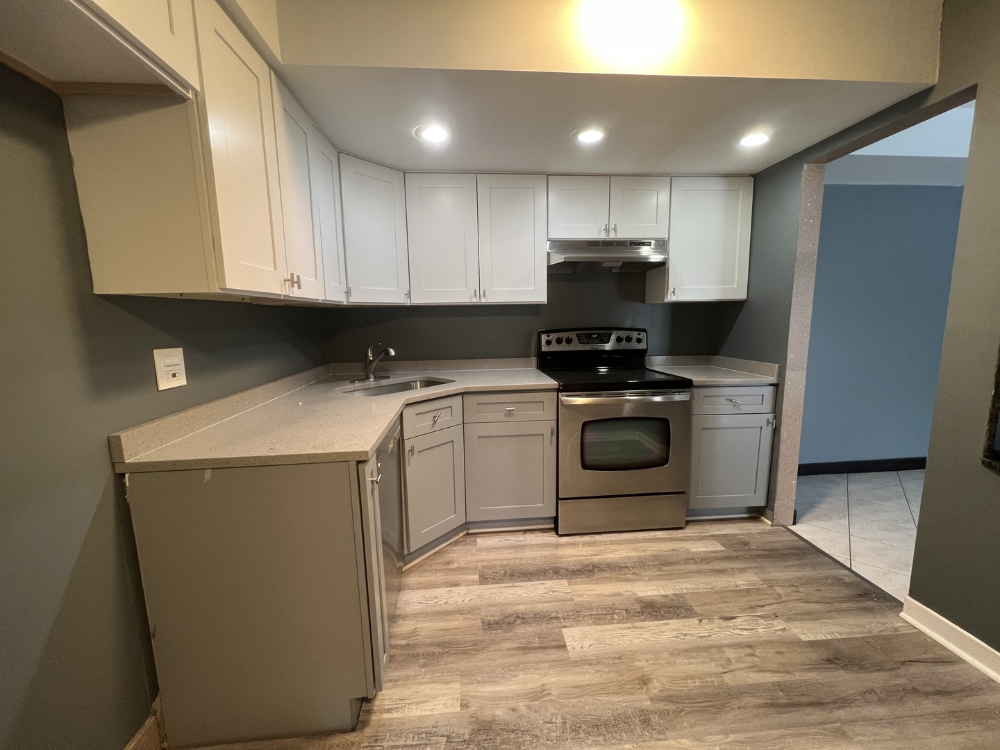 1111 Pleasant Run Drive, Unit 902 Wheeling, IL 60090 - Photo 2 of 7 a kitchen with a stove sink and a refrigerator