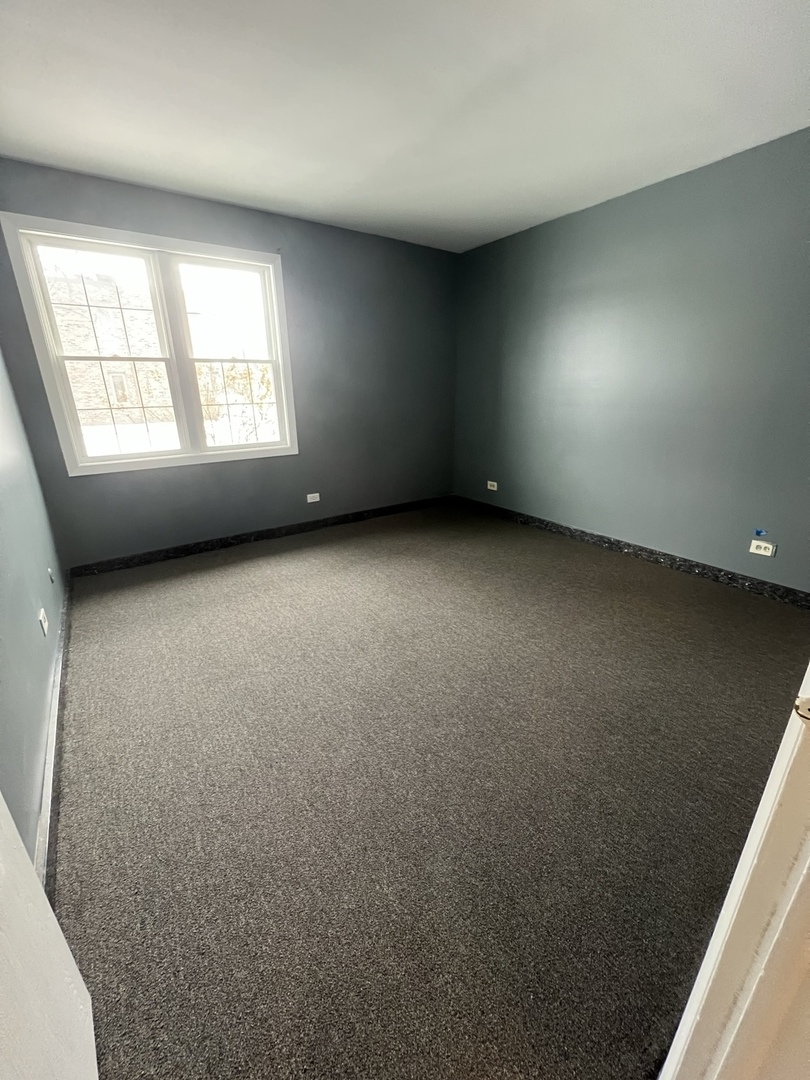1111 Pleasant Run Drive, Unit 902 Wheeling, IL 60090 - Photo 4 of 7 an empty room with a window