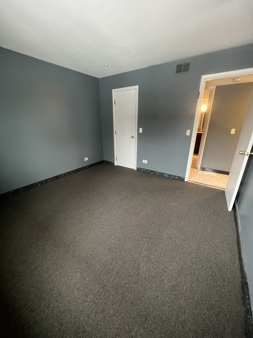 1111 Pleasant Run Drive, Unit 902 Wheeling, IL 60090 - Photo 5 of 7 an empty room with a window