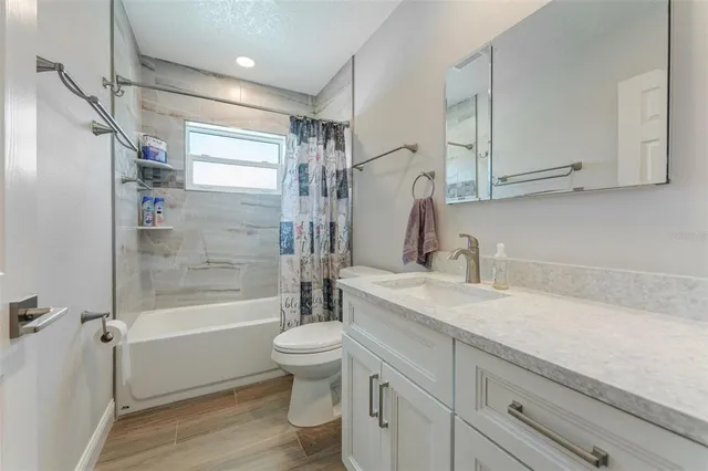 a large kitchen with kitchen island a sink a counter space and stainless steel appliances