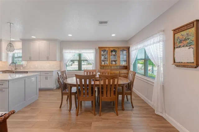 a dining room with furniture and a potted plant