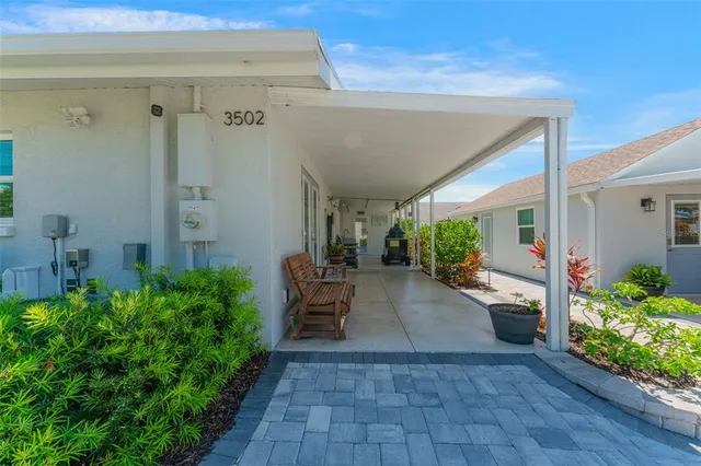 a bedroom with a bed and a lamp on dresser