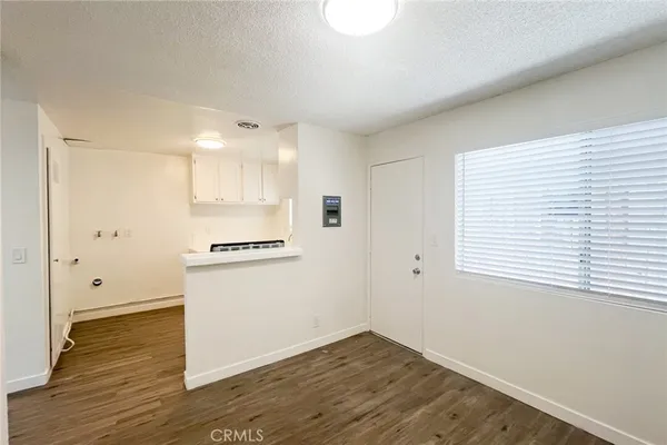 a view of a kitchen with wooden floor