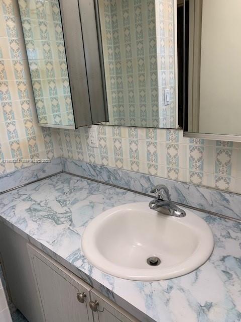 2690 Southwest 22nd Avenue, Unit 505 Miami, FL 33133 - Photo 13 of 21 a bathroom with a sink and a mirror