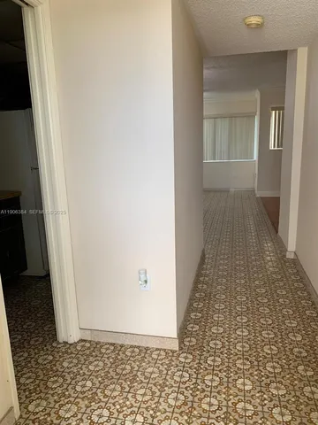 a room with furniture and a potted plant