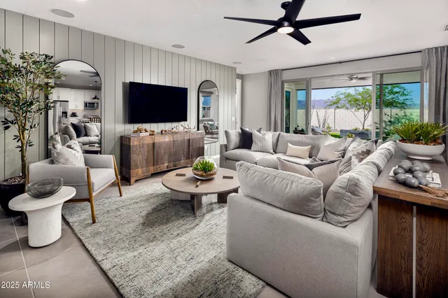 a kitchen with stainless steel appliances granite countertop a refrigerator a sink dishwasher a dining table and chairs with wooden floor