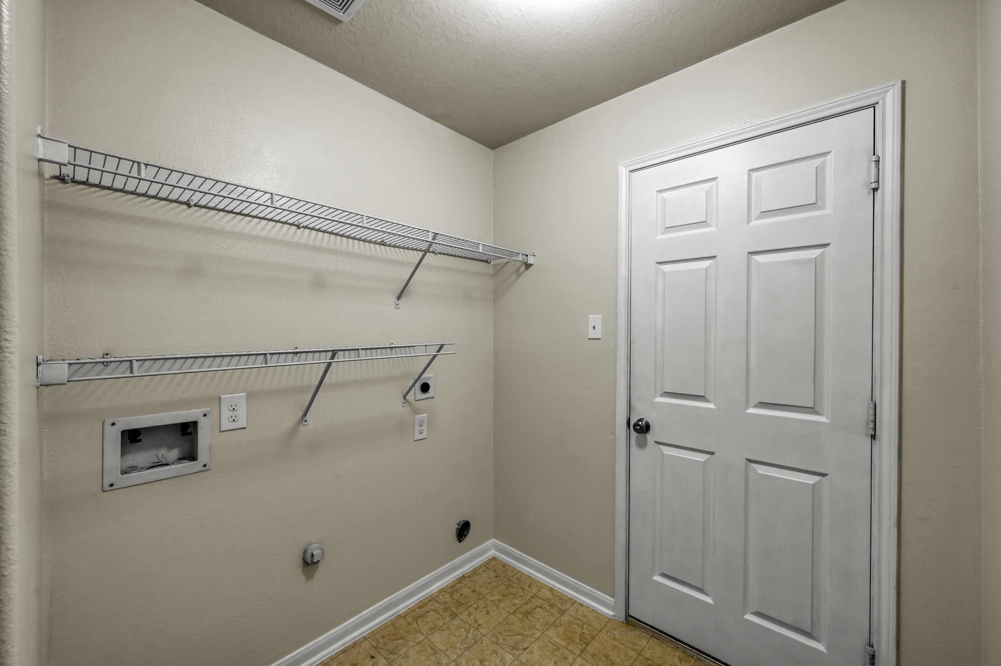631 Timberstand Lane Spring, TX 77373 - Photo 31 of 38 The interior utility room is conveniently located inside the home and features built-in shelving for additional laundry storage and organization.
