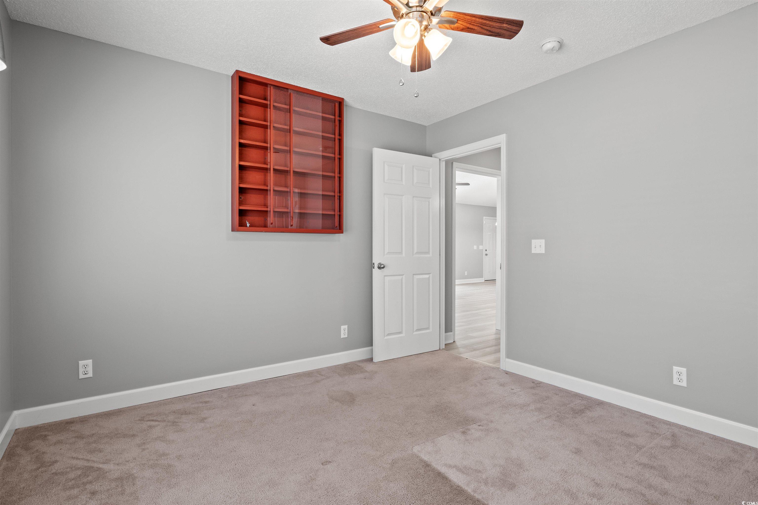125 Dayglow Drive Loris, SC 29569 - Photo 11 of 24 Carpeted empty room featuring a ceiling fan, a tex
