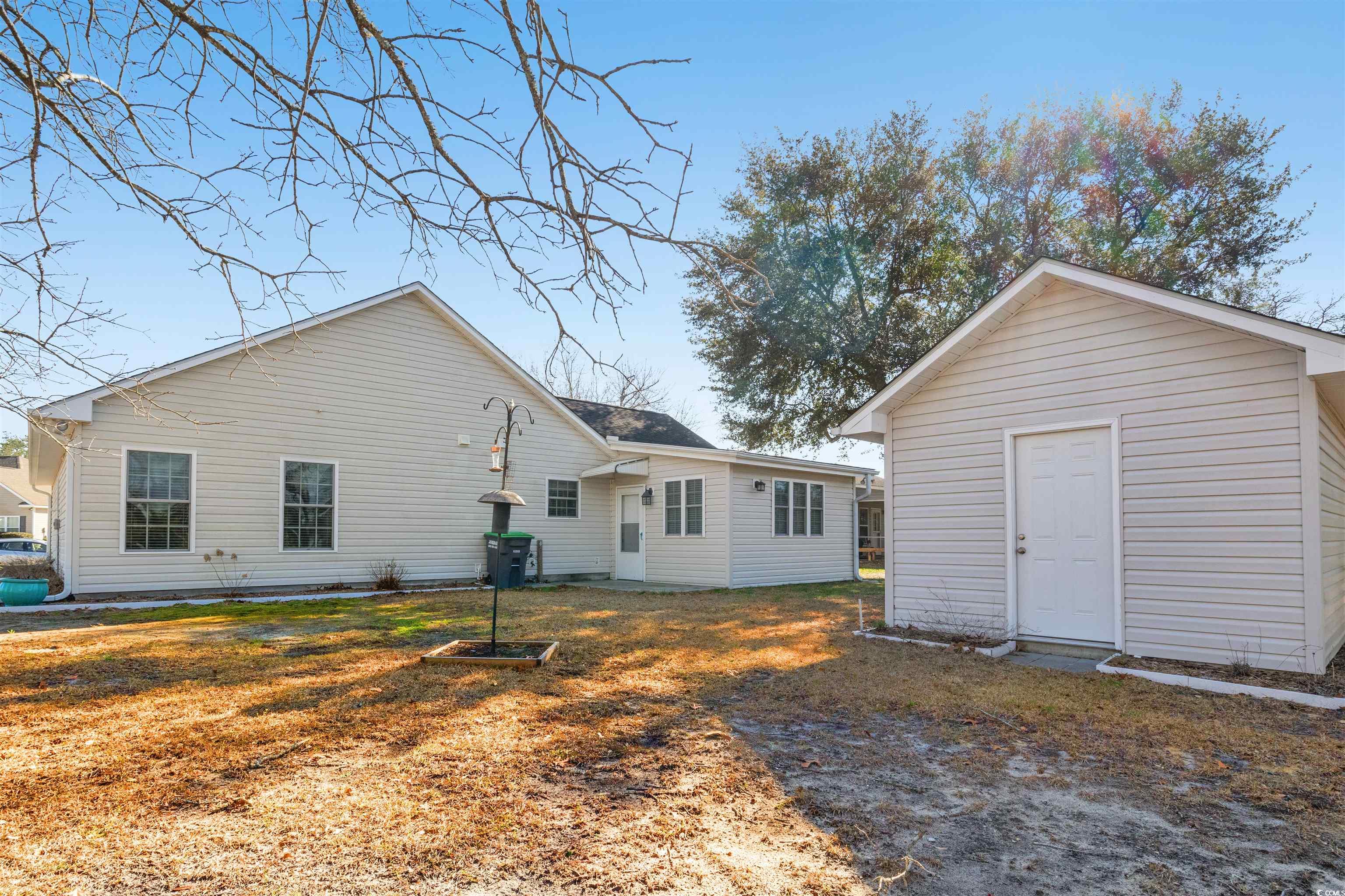 125 Dayglow Drive Loris, SC 29569 - Photo 23 of 24 Rear view of house featuring a yard and an outbuil