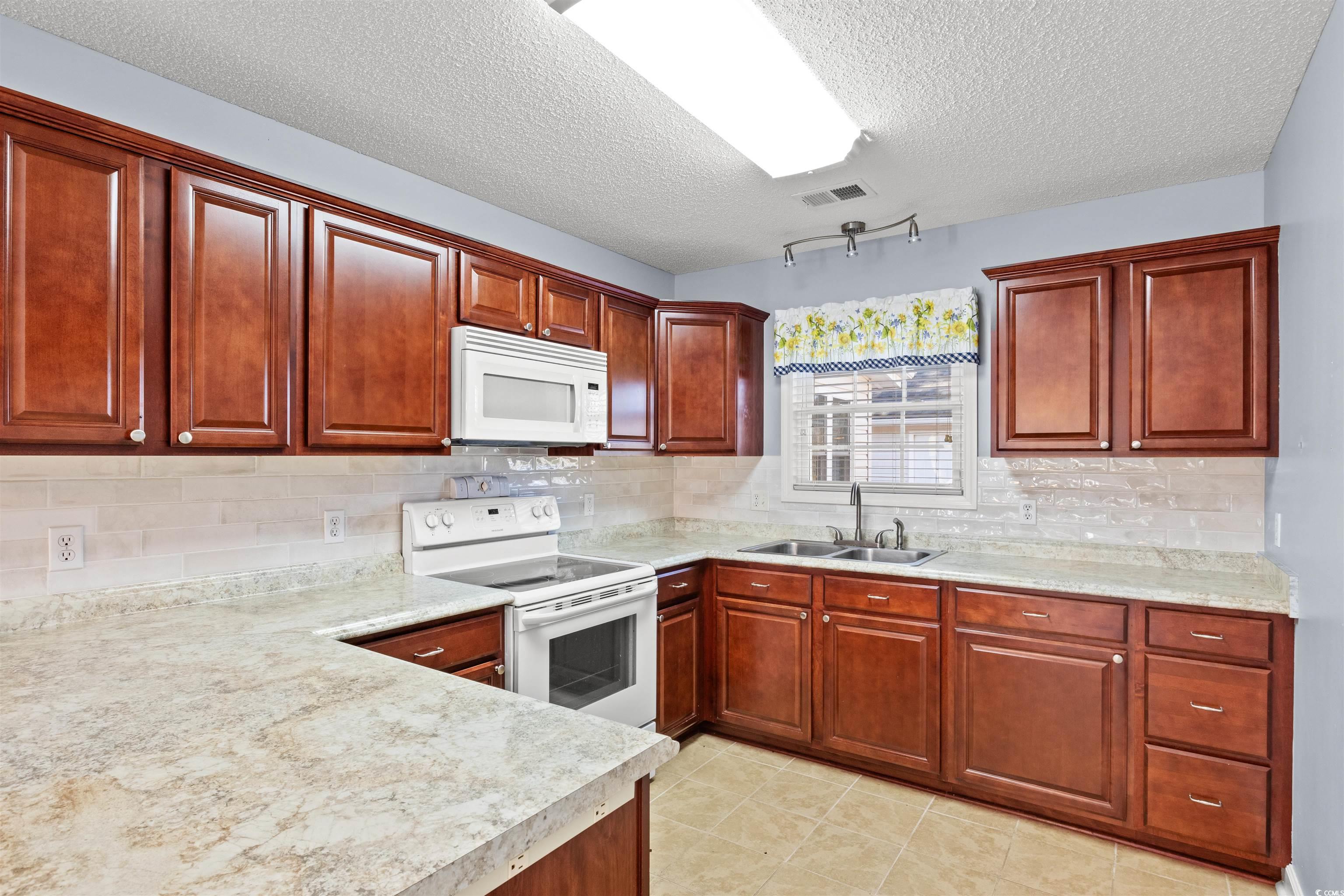 125 Dayglow Drive Loris, SC 29569 - Photo 8 of 24 Kitchen with light countertops, white appliances,