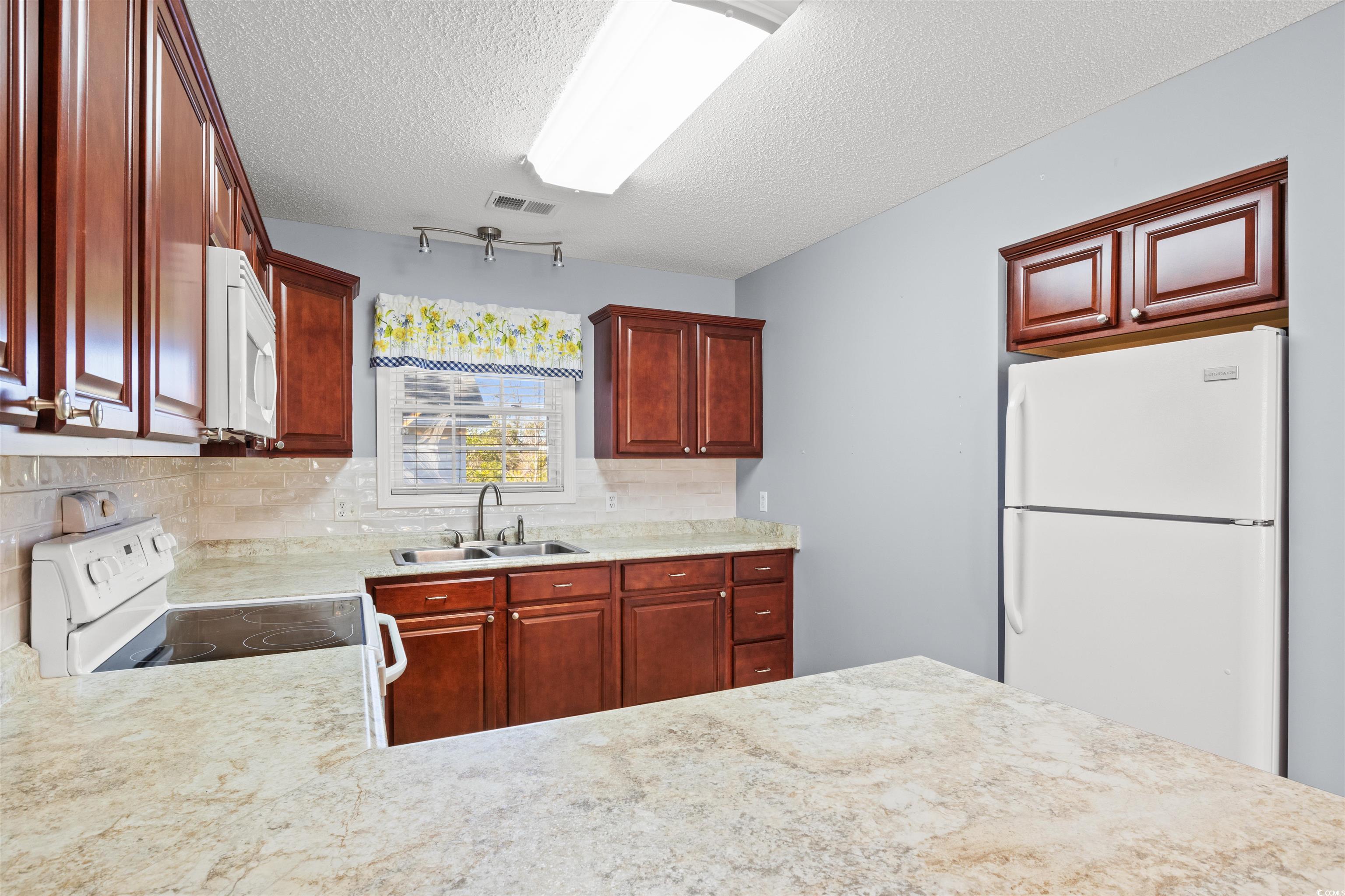 125 Dayglow Drive Loris, SC 29569 - Photo 9 of 24 Kitchen with light countertops, visible vents, dec