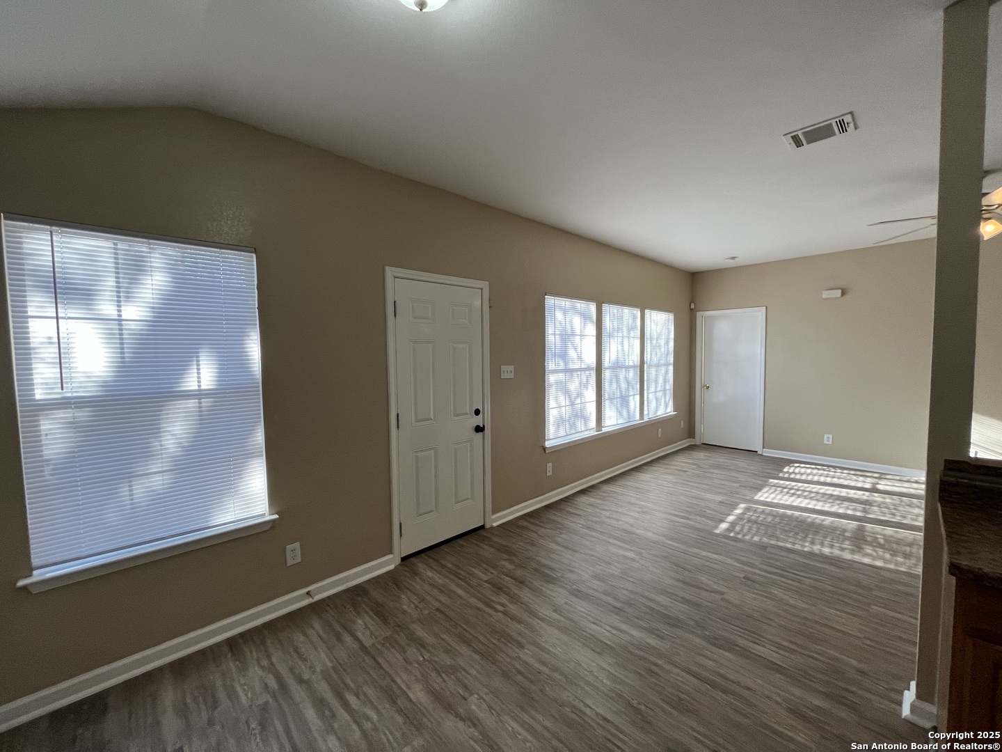 8806 Slumber Lane, Unit 101 Converse, TX 78109 - Photo 12 of 38 a view of an empty room with wooden floor and a window