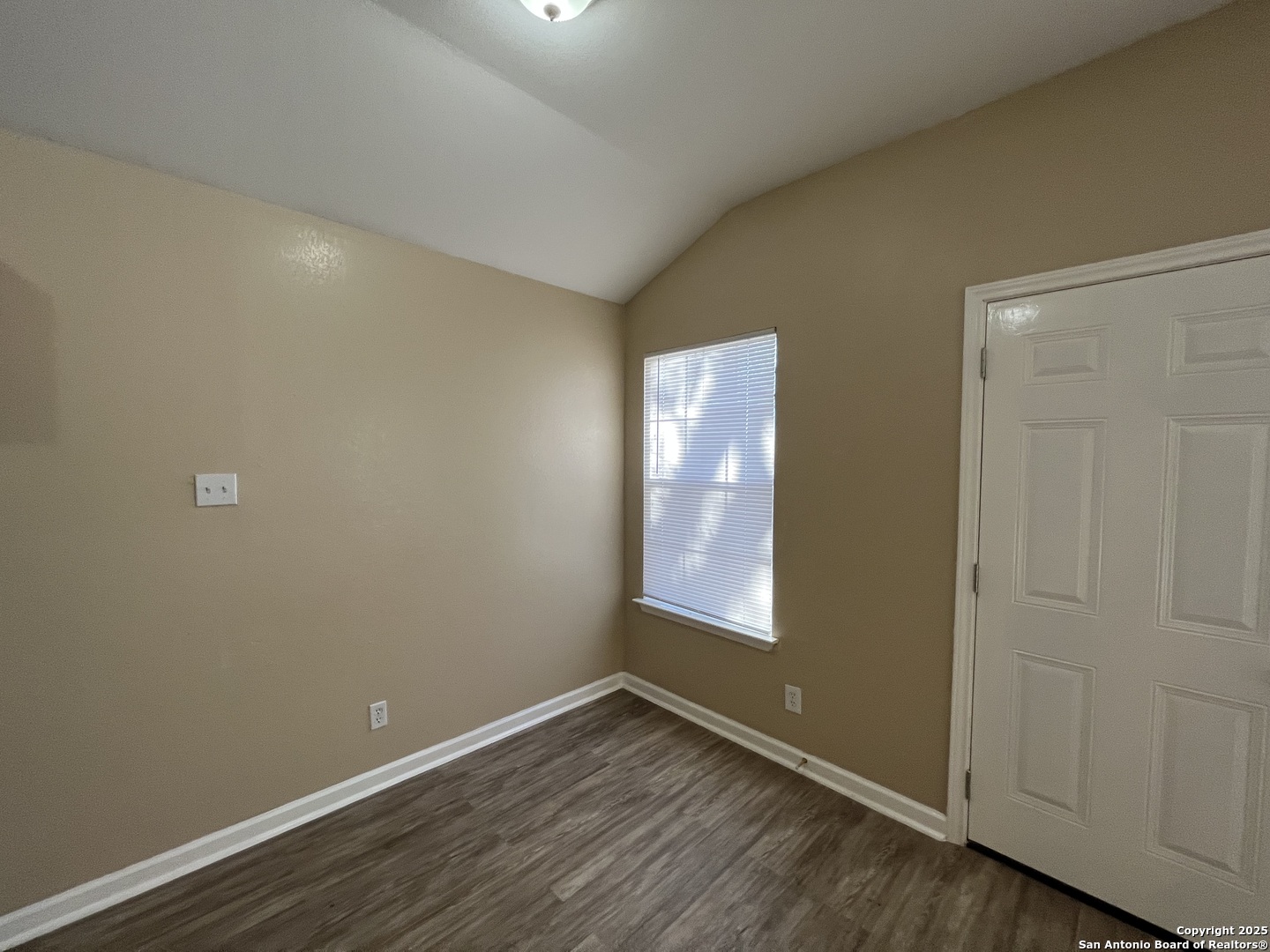 8806 Slumber Lane, Unit 101 Converse, TX 78109 - Photo 13 of 38 an empty room with wooden floor and windows