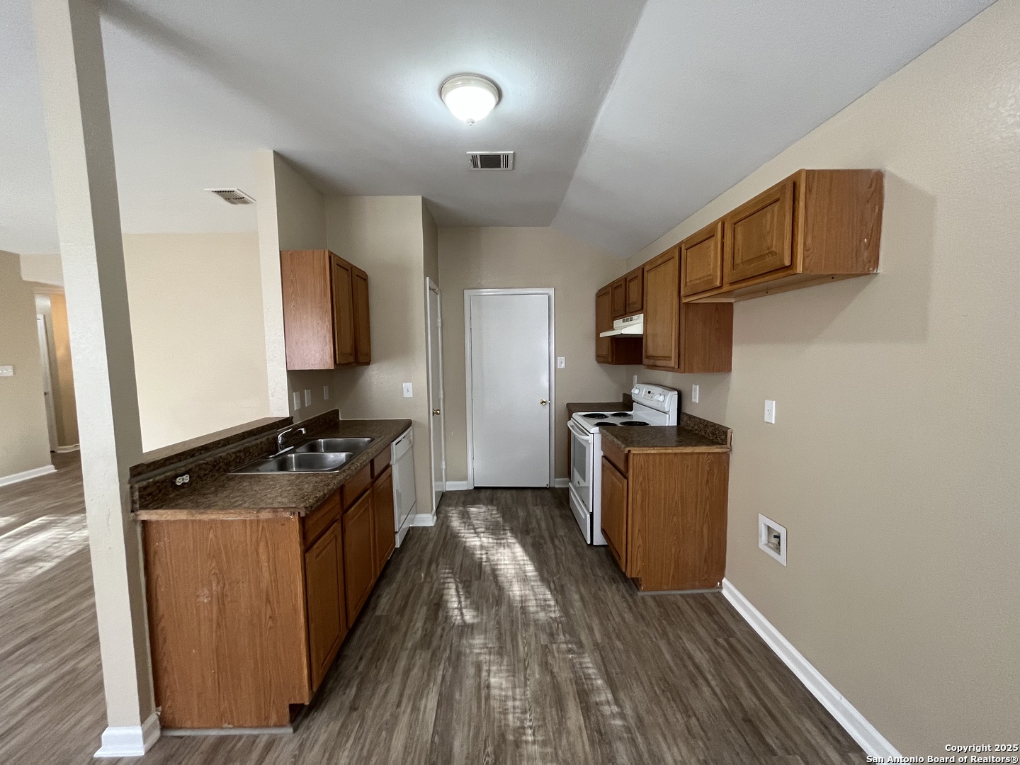 8806 Slumber Lane, Unit 101 Converse, TX 78109 - Photo 14 of 38 a kitchen with granite countertop a stove and a refrigerator