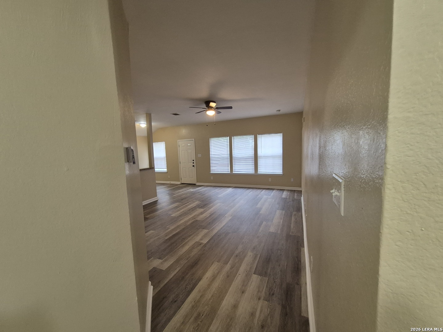 8806 Slumber Lane Converse, TX 78109 - Photo 16 of 39 a view of an empty room with wooden floor and a window