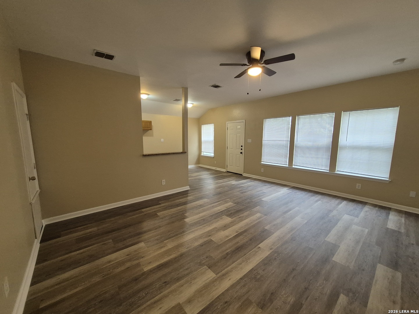 8806 Slumber Lane Converse, TX 78109 - Photo 17 of 39 a view of an empty room with a window and wooden floor