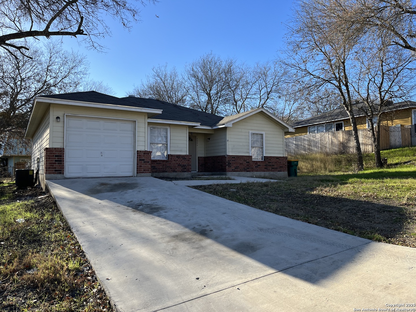 8806 Slumber Lane, Unit 101 Converse, TX 78109 - Photo 2 of 38 a front view of a house with a yard and garage