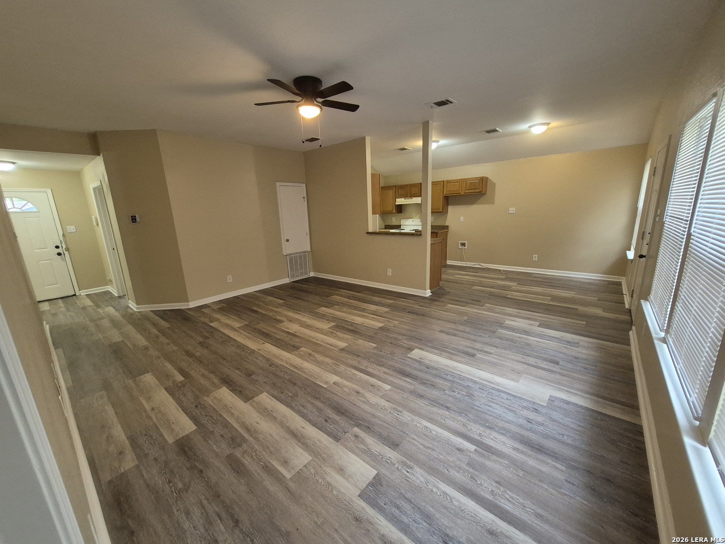 8806 Slumber Lane Converse, TX 78109 - Photo 21 of 39 a view of an empty room with wooden floor and a window