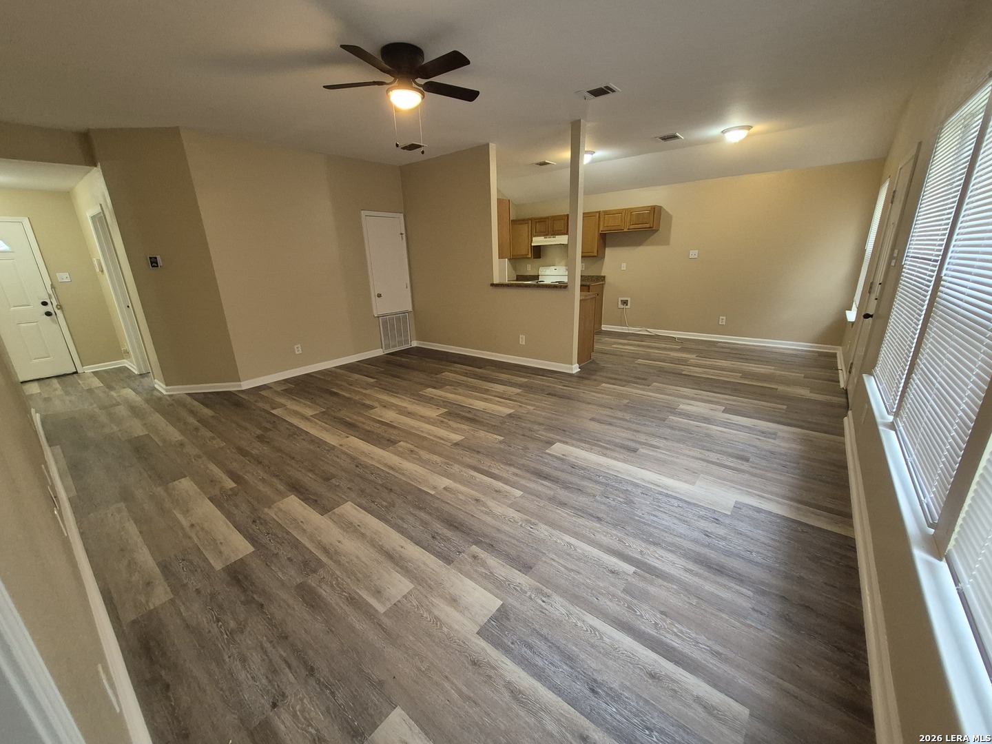 8806 Slumber Lane Converse, TX 78109 - Photo 22 of 39 a view of an empty room with wooden floor and a window