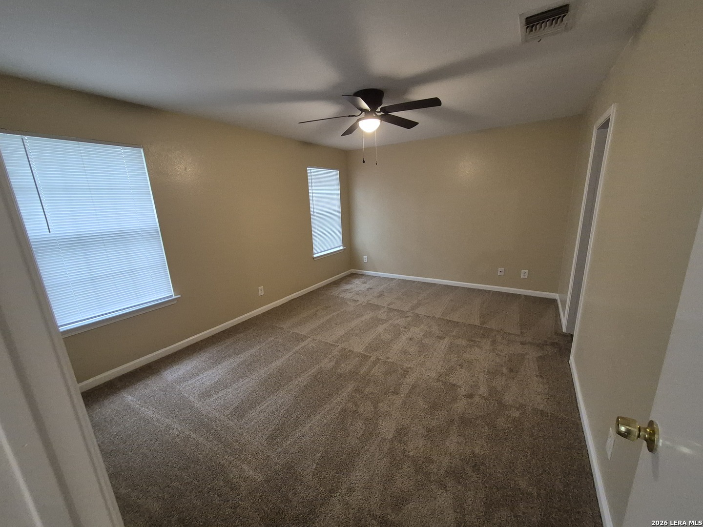 8806 Slumber Lane Converse, TX 78109 - Photo 23 of 39 an empty room with windows and fan