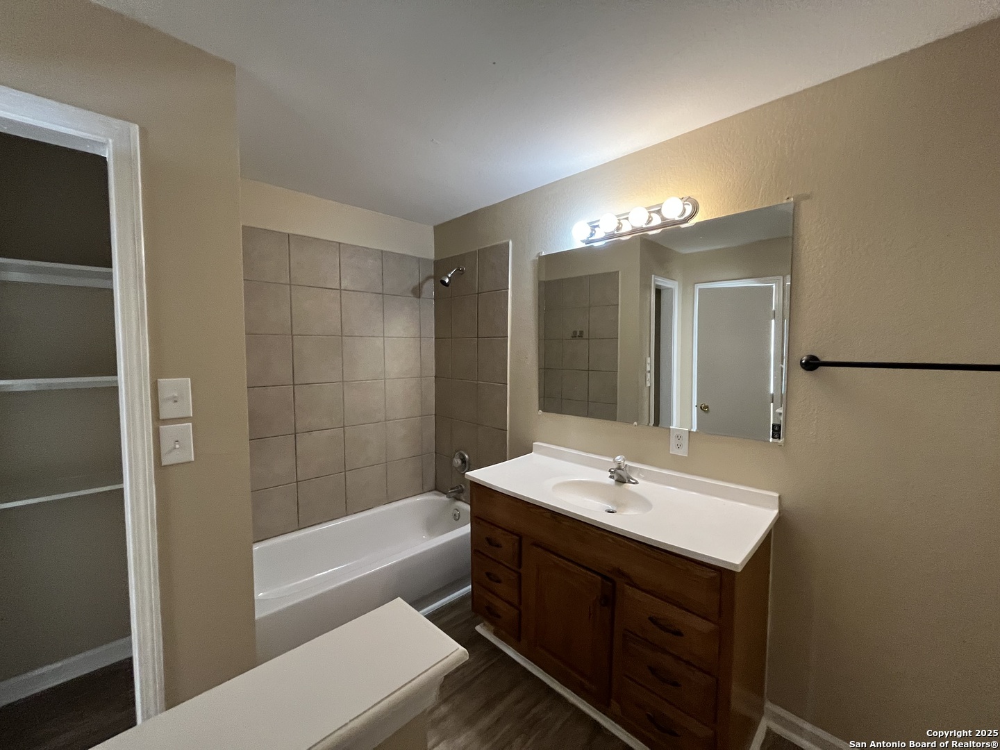 8806 Slumber Lane, Unit 101 Converse, TX 78109 - Photo 23 of 38 a bathroom with a sink a mirror and a bathtub