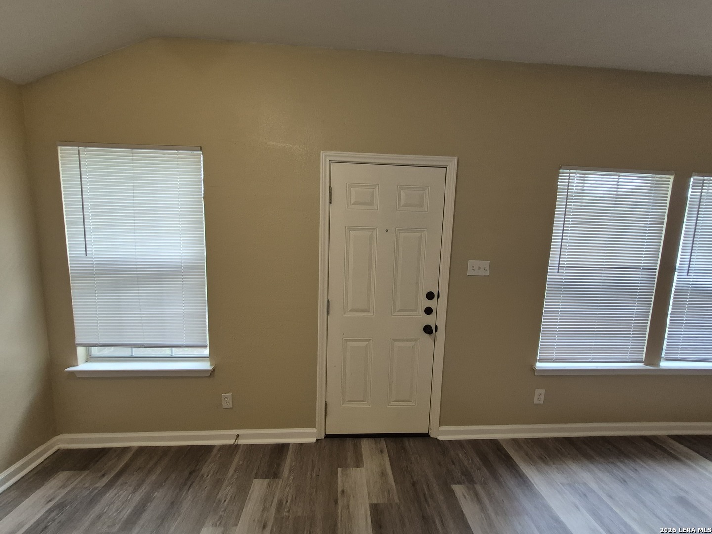 8806 Slumber Lane Converse, TX 78109 - Photo 34 of 39 an empty room with wooden floor and windows