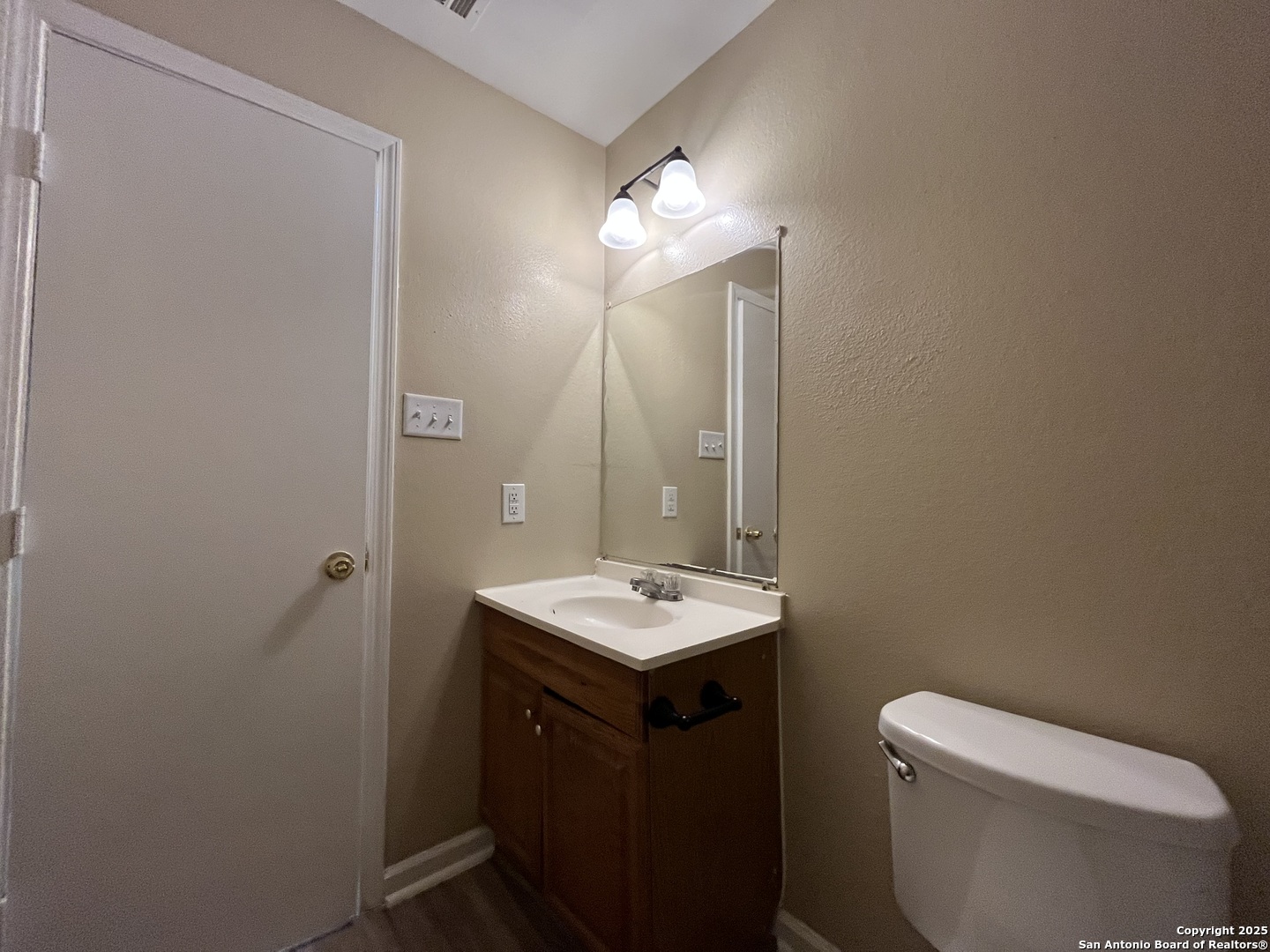 8806 Slumber Lane, Unit 101 Converse, TX 78109 - Photo 38 of 38 a bathroom with a toilet sink and mirror