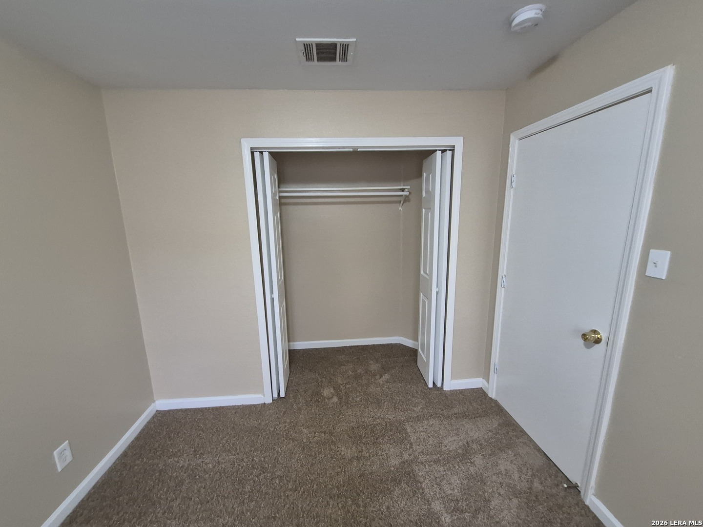 8806 Slumber Lane Converse, TX 78109 - Photo 6 of 39 an empty room that has a wooden door and closet