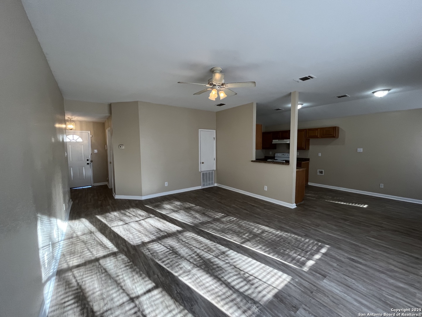 8806 Slumber Lane, Unit 101 Converse, TX 78109 - Photo 7 of 38 a view of a bedroom with wooden floor and a ceiling fan
