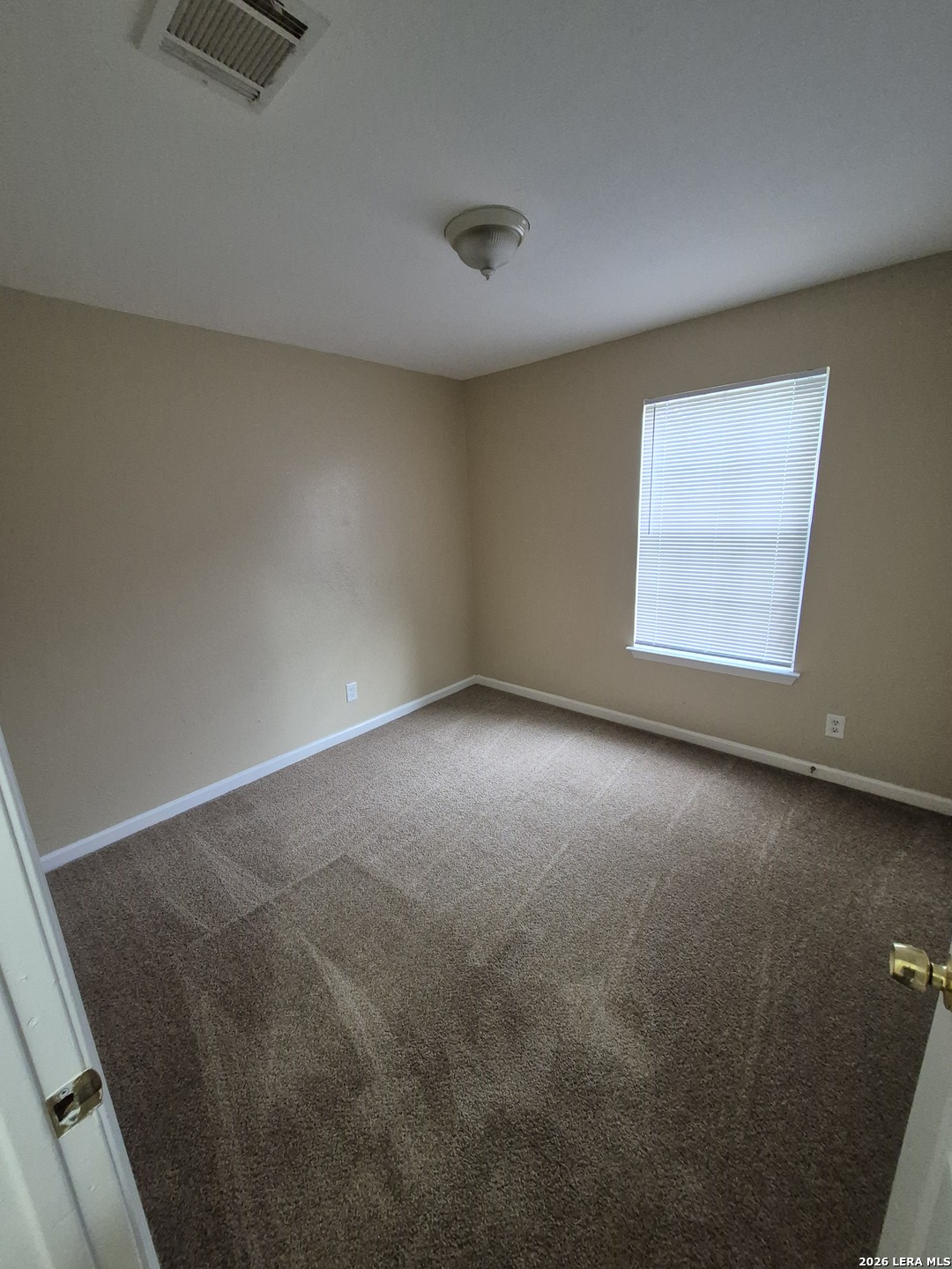 8806 Slumber Lane Converse, TX 78109 - Photo 8 of 39 an empty room with a empty space and a window