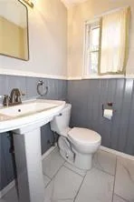 a bathroom with a sink a toilet and mirror
