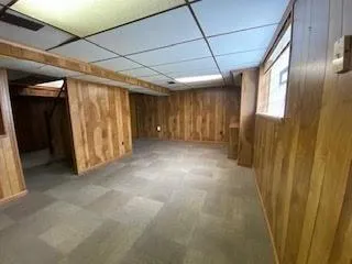 a view of hallway with wooden walls