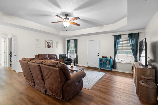 a view of a dining room with furniture wooden floor and chandelier