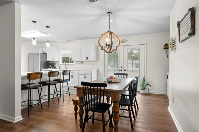 a kitchen with a refrigerator and a stove