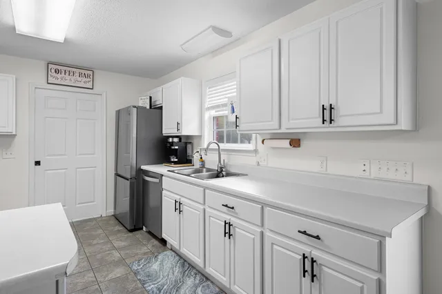 a large kitchen with cabinets and wooden floors