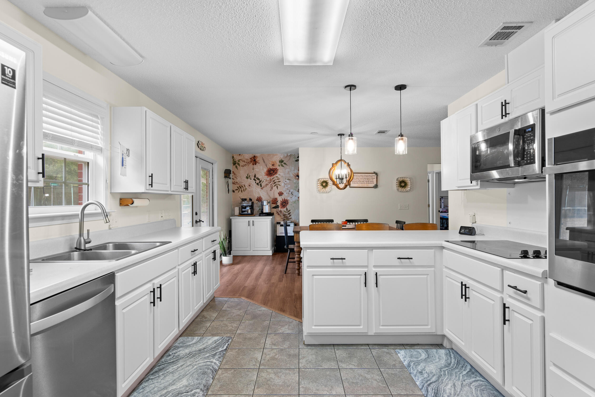 5570 Mt Olive Road Crestview, FL 32539 - Photo 25 of 57 a large kitchen with cabinets and wooden floors