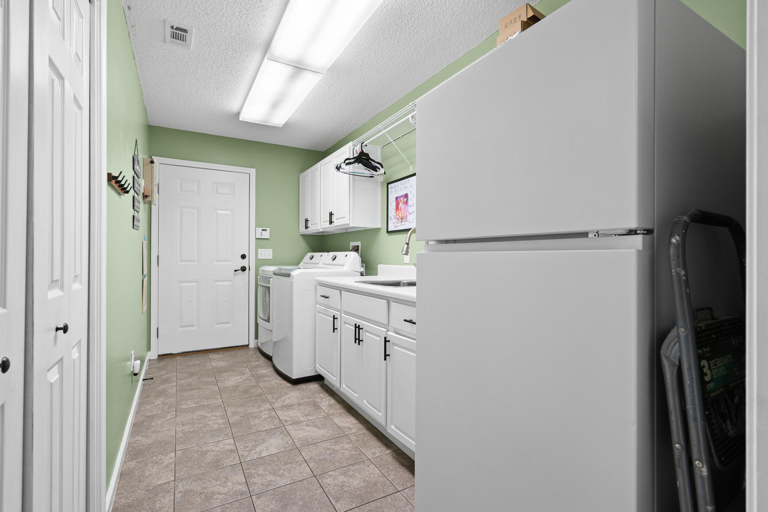 5570 Mt Olive Road Crestview, FL 32539 - Photo 26 of 57 a kitchen with white cabinets and refrigerator