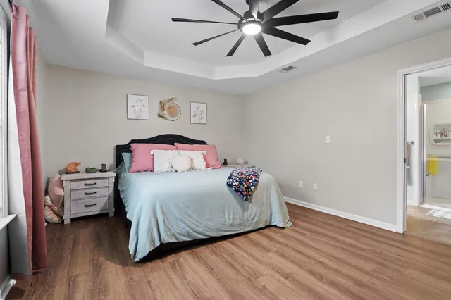a bedroom with furniture and a wooden floor
