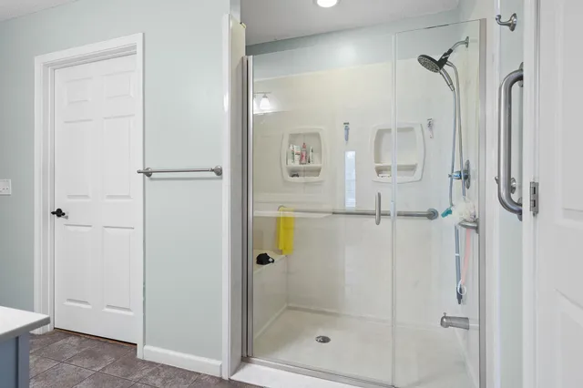 a bedroom with a large bed and a large window