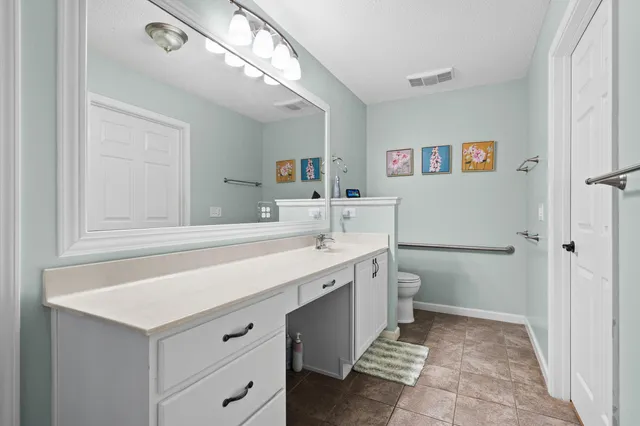 a bedroom with bed and a chandelier