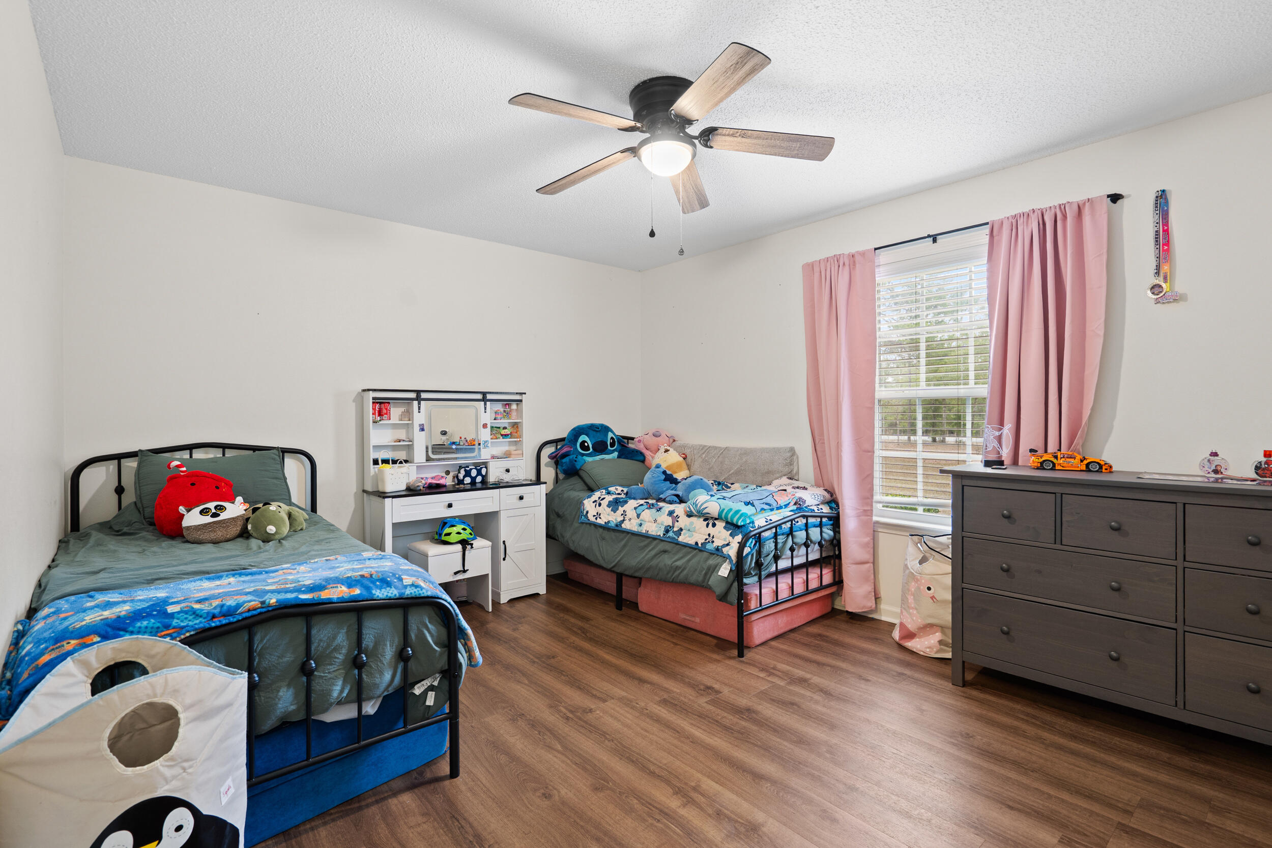 5570 Mt Olive Road Crestview, FL 32539 - Photo 34 of 57 a bedroom with furniture and a wooden floor