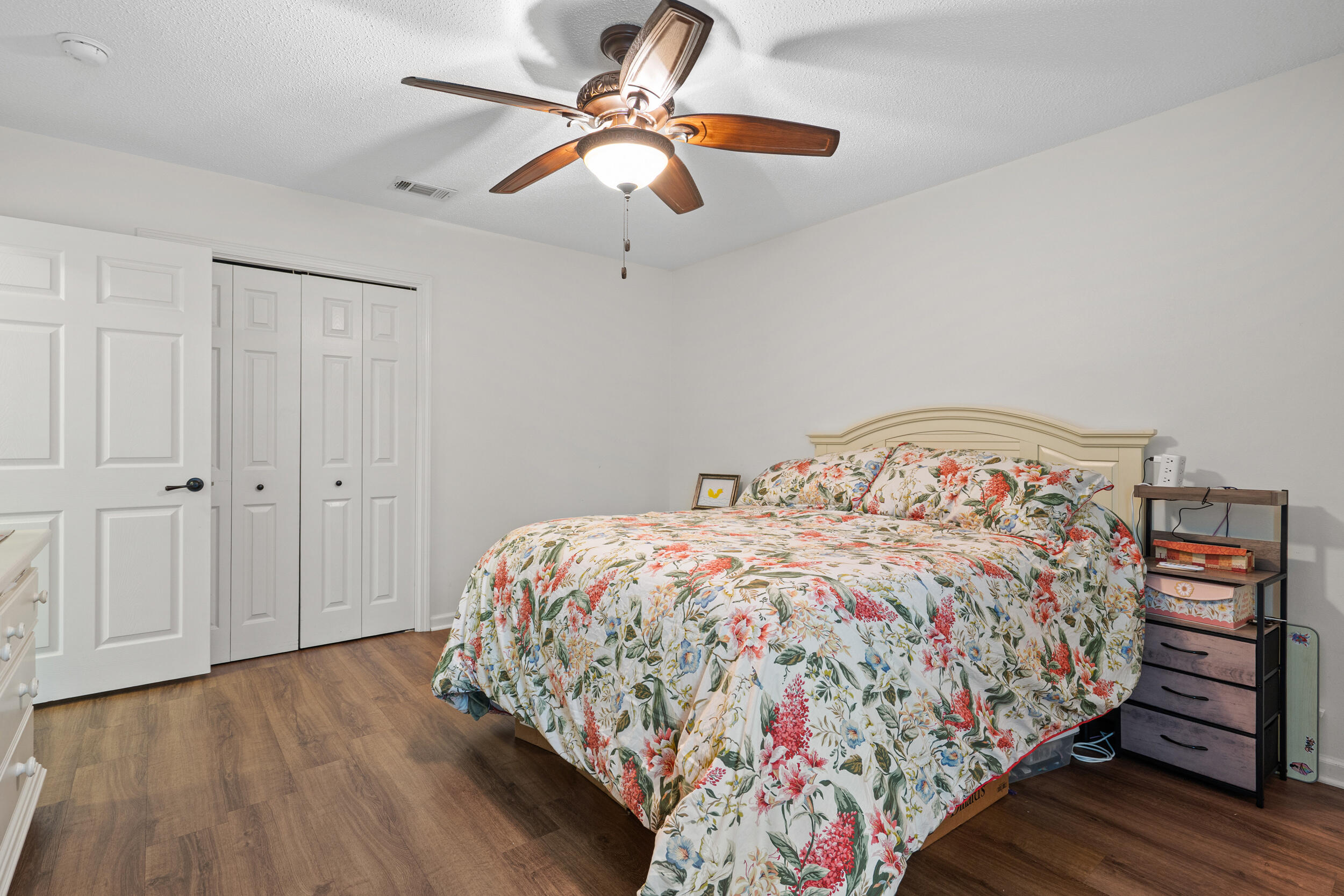 5570 Mt Olive Road Crestview, FL 32539 - Photo 39 of 57 a bedroom with bed and a chandelier