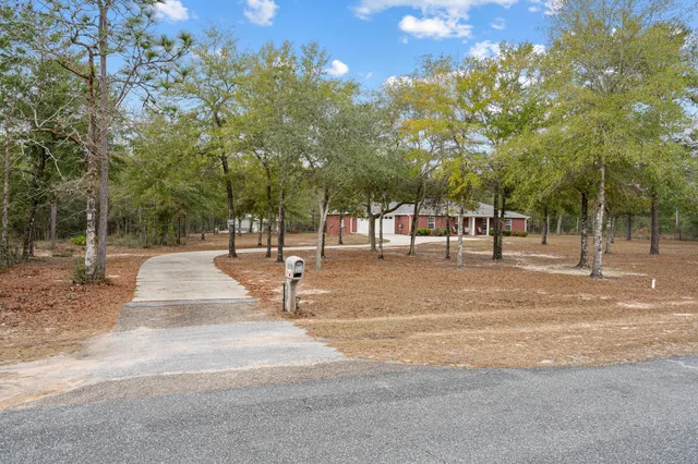 a front view of a house with a garden and porch