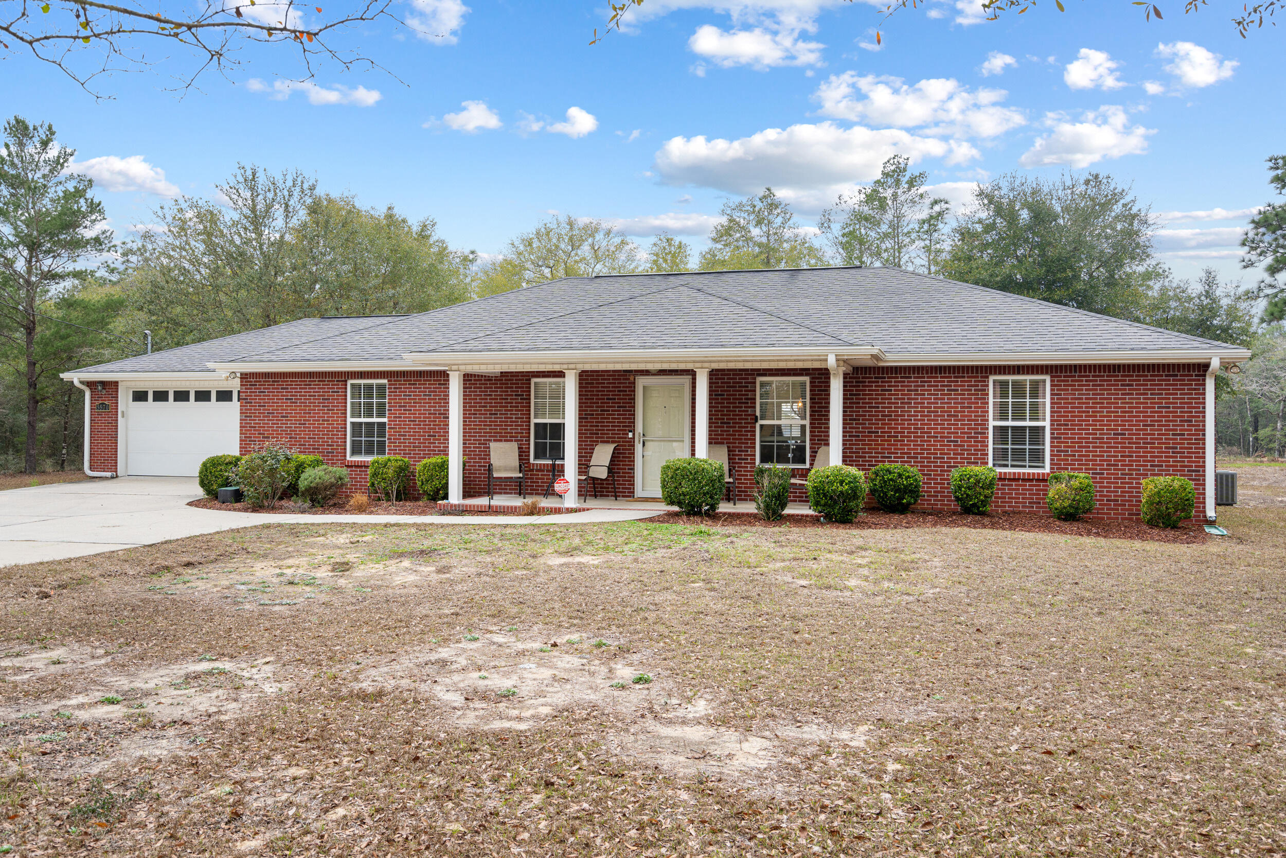 5570 Mt Olive Road Crestview, FL 32539 - Photo 5 of 57 a front view of a house with a garden and porch