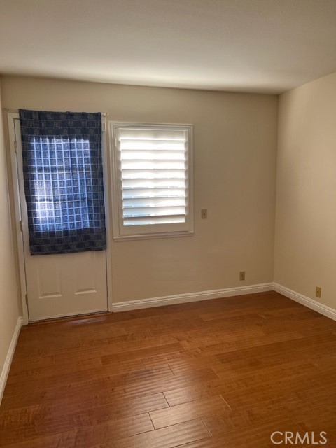 19616 Georgina Circle Cerritos, CA 90703 - Photo 13 of 16 an empty room with wooden floor and windows