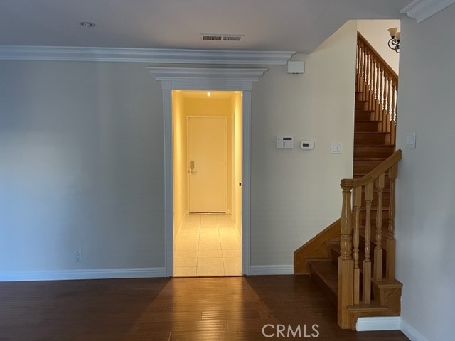19616 Georgina Circle Cerritos, CA 90703 - Photo 5 of 16 a view of a hallway with wooden floor and staircase